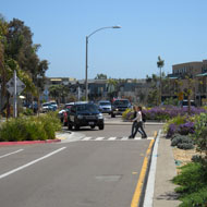 Roundabouts and medians help create pedestrian friendly short sidewalks. Source: MIG