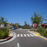 Traffic calming elements include well landscaped medians, bulbouts and roundabouts.Source: MIG