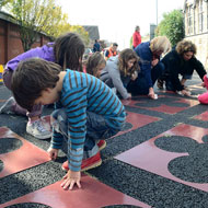 Creating a street carpet as part of Sustrans DIY Streets project to encourage drivers to drive slowly. Local residents, school children, Sustrans & Bristol City Council lay down the 'carpet'. Source: J Bewley/Sustrans